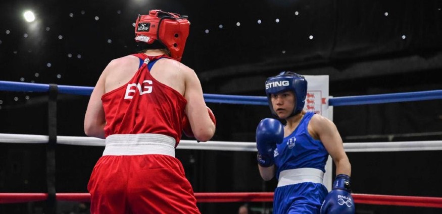 Rhea Kanu (blue vest) faces off against Abbie McKay (red vest) in the final of the GB Elite Three Nations boxing championship.